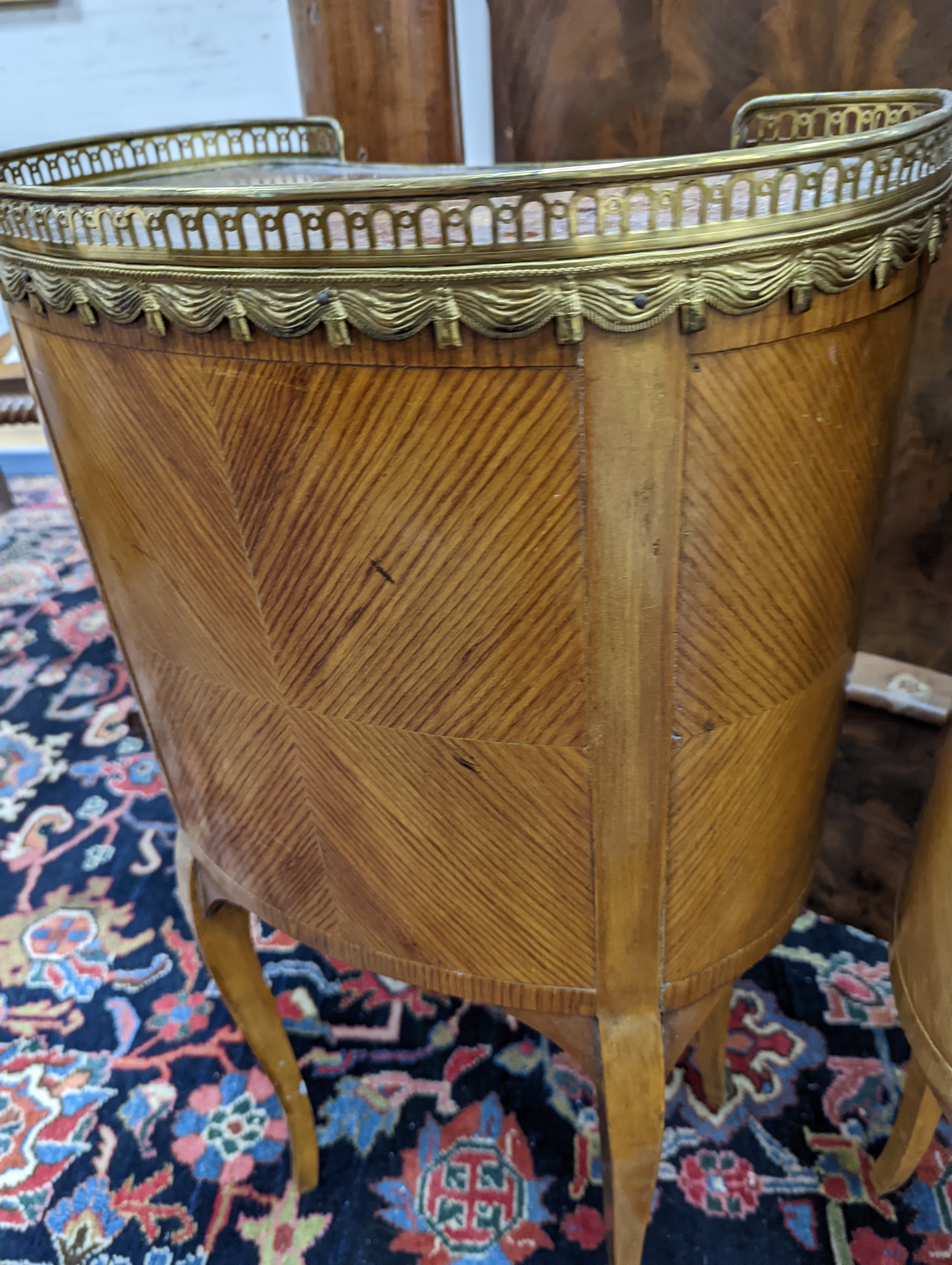 A pair of French marquetry inlaid gilt metal mounted kidney shaped two drawer bedside cabinets, width 42cm, depth 24cm, height 77cm